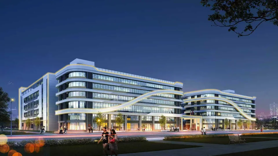 Maibahe campus at night with illuminated building facades and landscaped promenade